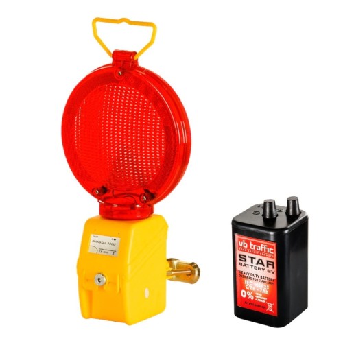Lampa drogowa zmierzchowa ministar 1000 z baterią, czerwona ostrzegawcza lampa błyskowa w kolorze czerwonym, stosowana do zabezpieczania miejsc niebezpiecznych.